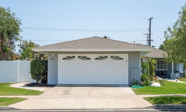 18211 Fairhaven Ave, North Tustin, CA 92705 - view of front of home with stucco siding, driveway, an attached garage, and a shingled roof