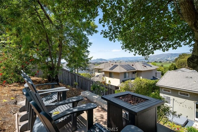 863 Greystone Pl, San Luis Obispo, CA 93401 - view of patio / terrace with an outdoor fire pit, a mountain view, and fence