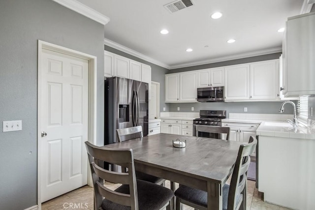 9229 Maywood Way, Riverside, CA 92503 - kitchen with appliances with stainless steel finishes, ornamental molding, a sink, white cabinetry, and recessed lighting