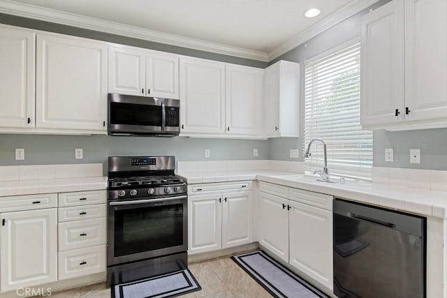 9229 Maywood Way, Riverside, CA 92503 - kitchen featuring appliances with stainless steel finishes, tile countertops, a sink, white cabinetry, and ornamental molding