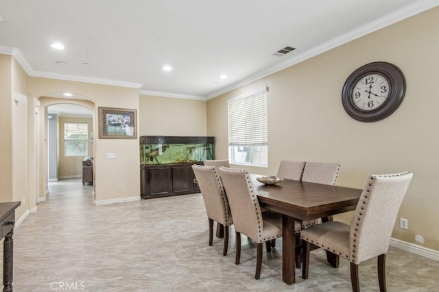9229 Maywood Way, Riverside, CA 92503 - dining space featuring arched walkways, crown molding, plenty of natural light, recessed lighting, and baseboards