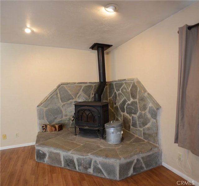 3809 Arroyo Trl, Frazier Park, CA 93225 - detailed view of baseboards, a wood stove, and wood finished floors