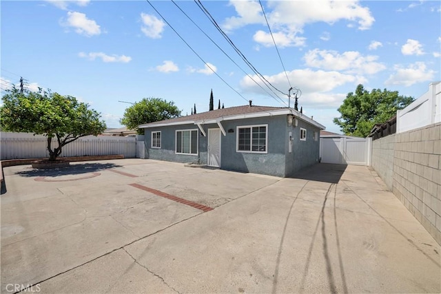 10117 Sharp Ave, Arleta, CA 91331 - rear view of property featuring stucco siding, a fenced backyard, a patio area, and a gate
