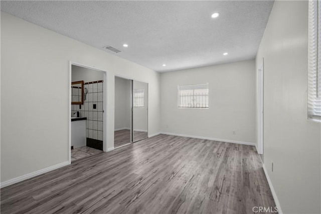 10117 Sharp Ave, Arleta, CA 91331 - unfurnished bedroom with wood finished floors, baseboards, recessed lighting, a textured ceiling, and a closet