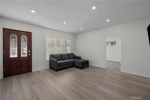 10117 Sharp Ave, Arleta, CA 91331 - living area featuring light wood-style flooring, a textured ceiling, baseboards, and recessed lighting