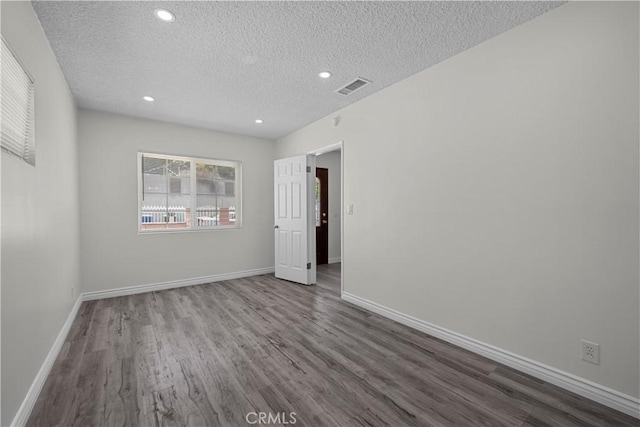 10117 Sharp Ave, Arleta, CA 91331 - spare room featuring a textured ceiling, wood finished floors, baseboards, and recessed lighting