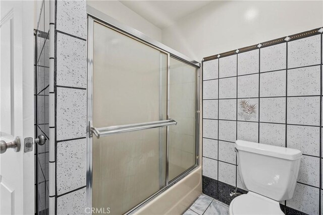 10117 Sharp Ave, Arleta, CA 91331 - bathroom with toilet, combined bath / shower with glass door, and tile walls