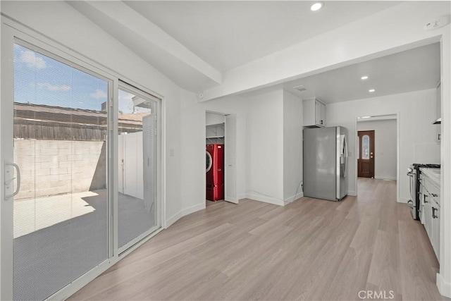 10117 Sharp Ave, Arleta, CA 91331 - unfurnished living room with light wood finished floors, recessed lighting, washer and clothes dryer, and baseboards