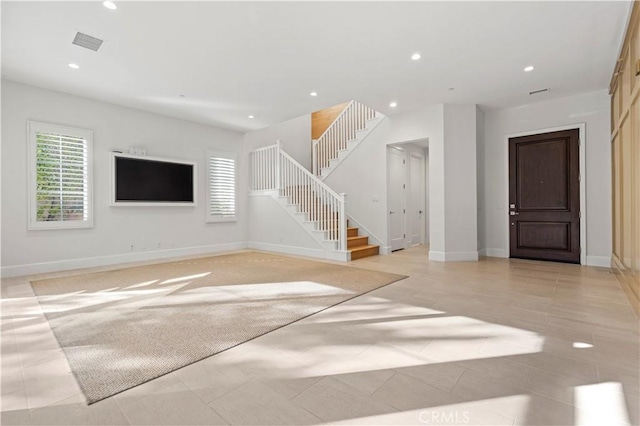 unfurnished living room featuring stairway, recessed lighting, baseboards, and light tile patterned floors