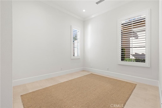 empty room featuring baseboards, ornamental molding, and recessed lighting