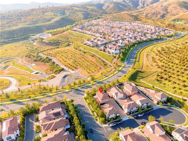 aerial overview of property's location featuring a mountain backdrop and nearby suburban area
