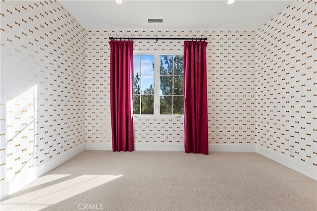 carpeted empty room with wallpapered walls, baseboards, and recessed lighting