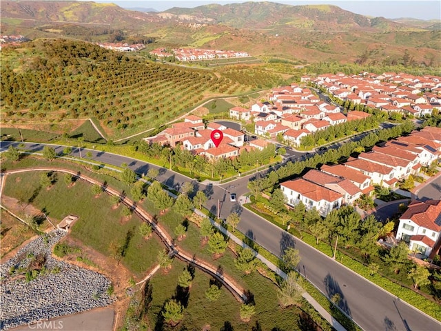 view of property location with a mountain backdrop and nearby suburban area