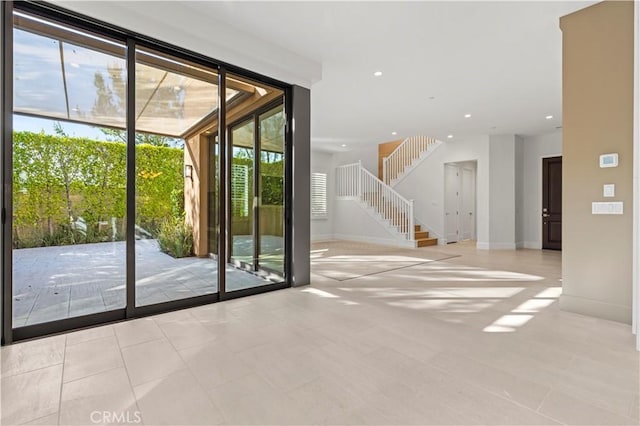 doorway to outside with stairway, recessed lighting, and baseboards