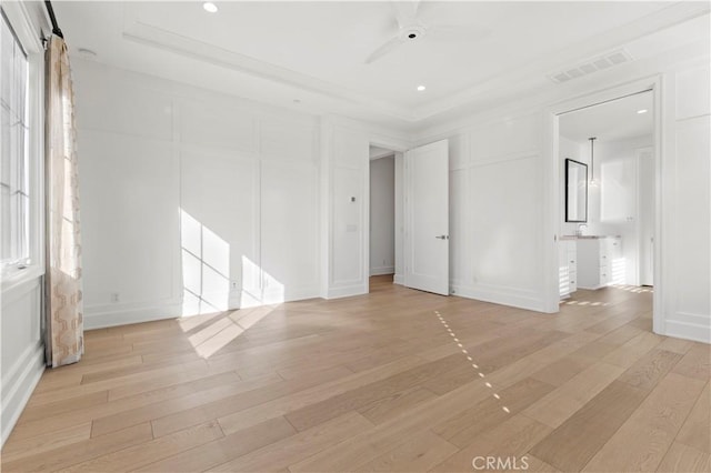 unfurnished bedroom featuring a decorative wall, light wood-style floors, recessed lighting, crown molding, and a ceiling fan