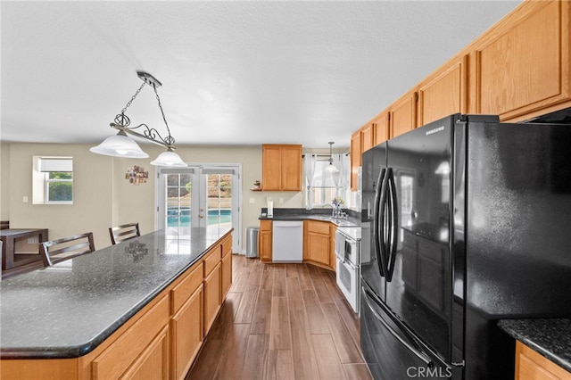 27876 Twilight Ct, Murrieta, CA 92563 - kitchen featuring freestanding refrigerator, white dishwasher, dark wood-style floors, decorative light fixtures, and a center island