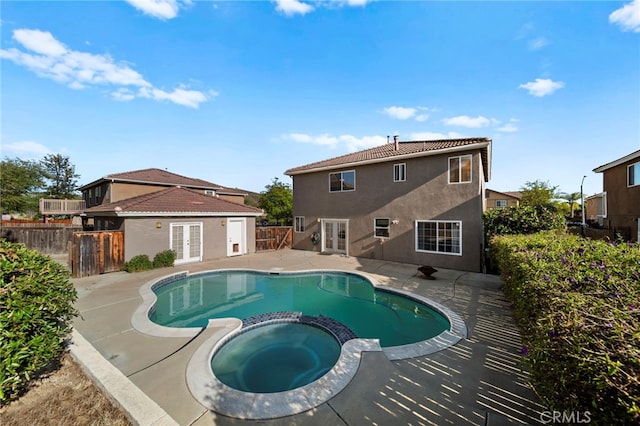 27876 Twilight Ct, Murrieta, CA 92563 - view of swimming pool with french doors, a pool with connected hot tub, a patio area, and a fenced backyard
