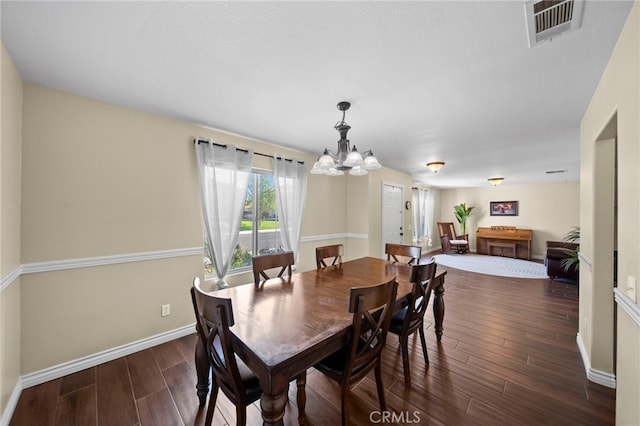 27876 Twilight Ct, Murrieta, CA 92563 - dining space featuring a chandelier, dark wood-type flooring, and baseboards