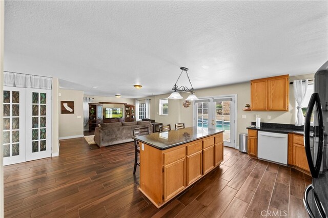 27876 Twilight Ct, Murrieta, CA 92563 - kitchen with french doors, dishwasher, dark countertops, dark wood-style floors, and freestanding refrigerator