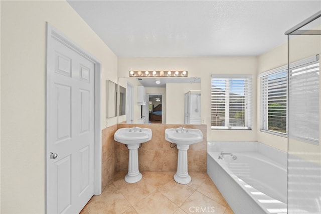 27876 Twilight Ct, Murrieta, CA 92563 - ensuite bathroom with tile patterned floors, a garden tub, a shower with shower door, tile walls, and wainscoting