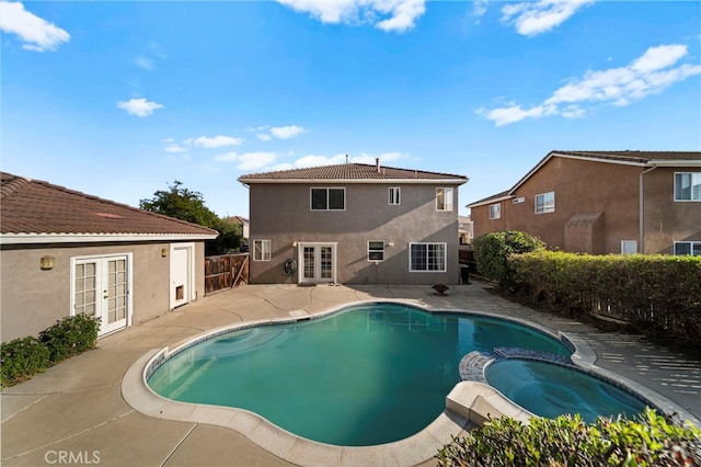 27876 Twilight Ct, Murrieta, CA 92563 - view of pool featuring french doors, a patio, a pool with connected hot tub, and a fenced backyard