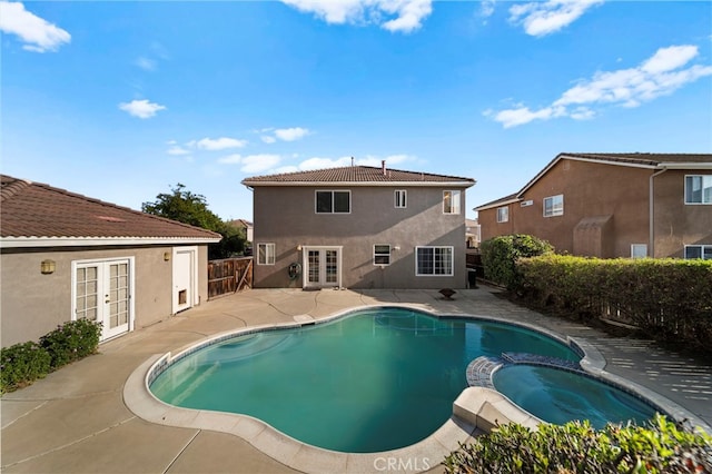 27876 Twilight Ct, Murrieta, CA 92563 - view of pool with french doors, a patio area, a pool with connected hot tub, and a fenced backyard