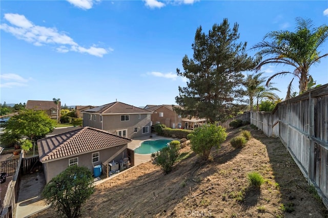 27876 Twilight Ct, Murrieta, CA 92563 - rear view of house with a fenced backyard, a residential view, stucco siding, and a tile roof