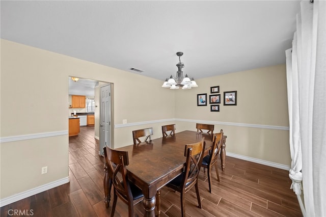 27876 Twilight Ct, Murrieta, CA 92563 - dining space featuring dark wood-type flooring, a chandelier, and baseboards