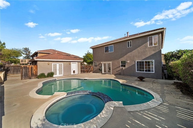 27876 Twilight Ct, Murrieta, CA 92563 - view of swimming pool with french doors, a pool with connected hot tub, a patio area, and a fenced backyard