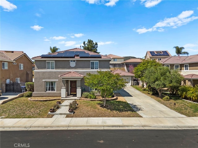 27876 Twilight Ct, Murrieta, CA 92563 - view of front of home with stucco siding, a tiled roof, roof mounted solar panels, and a residential view