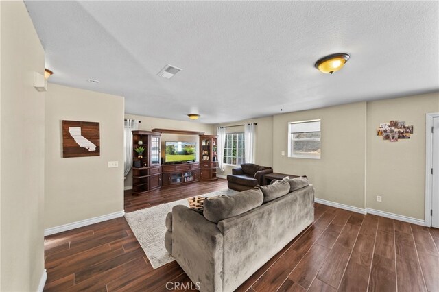 27876 Twilight Ct, Murrieta, CA 92563 - living area featuring dark wood-type flooring, baseboards, and a textured ceiling