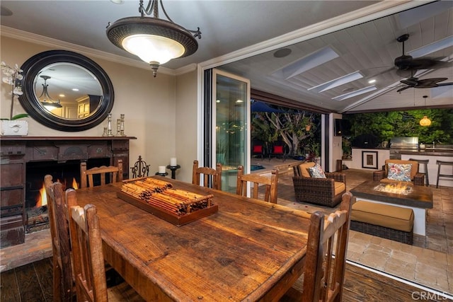 dining space featuring a ceiling fan, ornamental molding, and wood finished floors