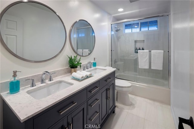 bathroom featuring double vanity, toilet, shower / bath combination with glass door, tile patterned flooring, and recessed lighting