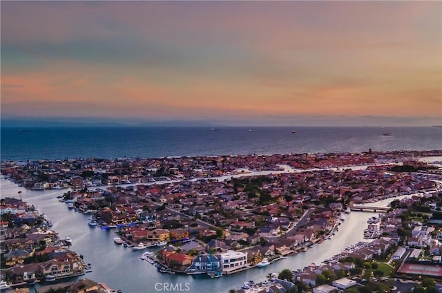 aerial overview of property's location featuring a large body of water and nearby suburban area