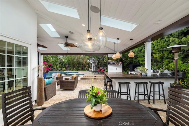 deck featuring a patio area, an outdoor hangout area, ceiling fan, and an outdoor pool