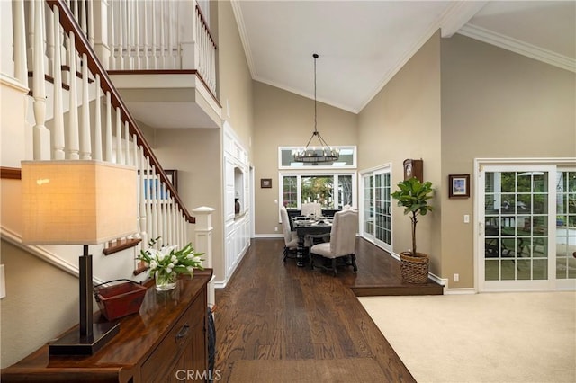 entrance foyer with ornamental molding, stairs, high vaulted ceiling, wood finished floors, and baseboards