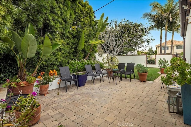 view of patio with a gate and fence