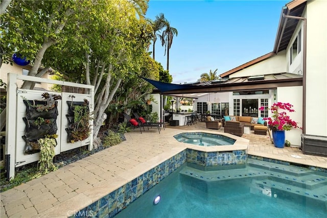 view of pool with outdoor lounge area, an in-ground hot tub, and a patio area