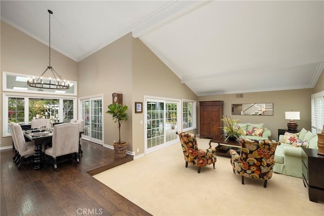 living room with a chandelier, wood finished floors, high vaulted ceiling, baseboards, and ornamental molding