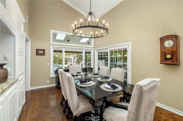 dining space featuring a high ceiling, baseboards, ornamental molding, dark wood finished floors, and plenty of natural light