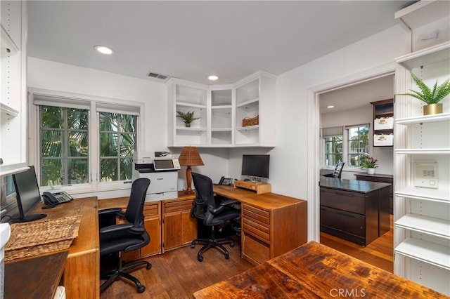 office with dark wood-type flooring and recessed lighting