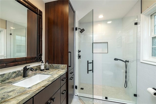 bathroom with vanity and a stall shower