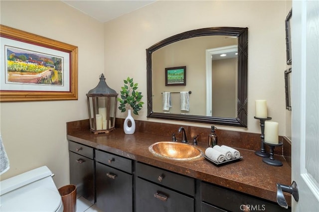 half bathroom with vanity and toilet