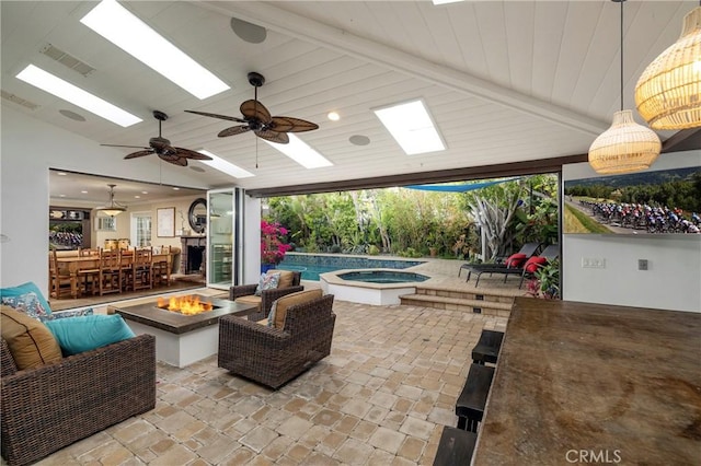 view of patio with an outdoor fire pit, an outdoor pool, a ceiling fan, and an in-ground hot tub