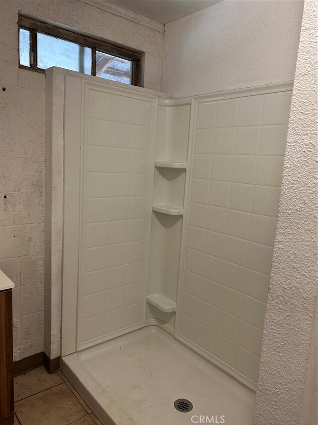 bathroom featuring a shower stall, vanity, and tile patterned floors