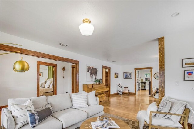 living room with light wood finished floors and baseboards