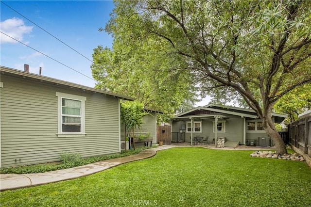 rear view of house featuring central air condition unit and a patio area