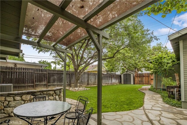 view of patio / terrace with a storage shed, central AC, an outdoor structure, a pergola, and outdoor dining area