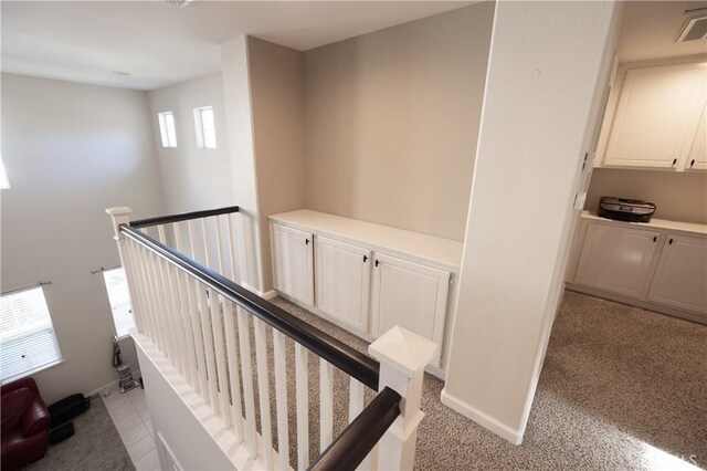 stairway featuring carpet and baseboards