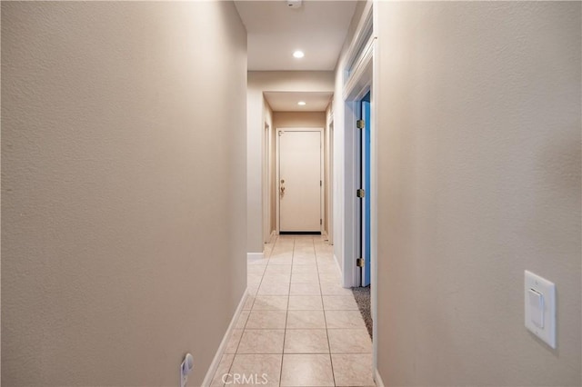 hall with light tile patterned flooring, baseboards, and recessed lighting